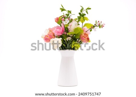 Elegant mixed pastel colored spring bouquet in white vase on white background. Spring flowers. Tulips bouquet.