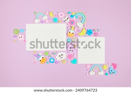 Two blank white cards on pastel purple background with frame of cute kawaii air plasticine handmade cartoon animals, rainbows. Empty photo frames, baby's photo book, scrapbooking design template