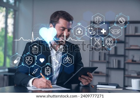 Considered businessman in formal wear signing contract holding tablet device at office room with papers. Concept of successful business deal, agreement, partnership, documents. Medical icons.
