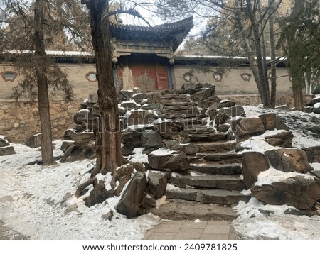 Stairs trail to the gate at Summer Palace, Beijing, China. The part of  both sides trail covered with snow