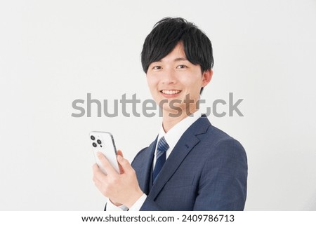 Asian businessman using the smartphone in white background