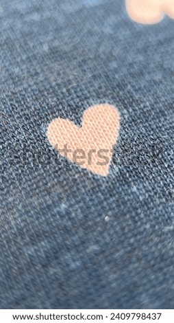pink heart print on blue fabric macro photo
