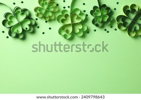 Frame top border made of four leaf clover paper cut and confetti on green background. Saint Patricks Day banner design Royalty-Free Stock Photo #2409798643