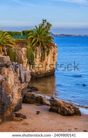 Resort town of Cascais in Portugal, scenic cliff at Praia da Rainha beach at the Atlantic Ocean in Lisbon District. Royalty-Free Stock Photo #2409800141