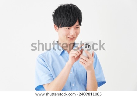 Asian man using the smartphone in white background