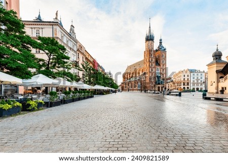 Old town of Cracow, Poland with St. Mary's Basilica and restaurants. Royalty-Free Stock Photo #2409821589