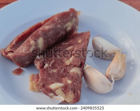 Fermented beef Laos food, Raw meat mixed with garlic and salt. Royalty-Free Stock Photo #2409835523