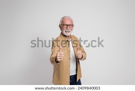 Successful senior businessman smiling and showing thumbs up gesture over isolated white background