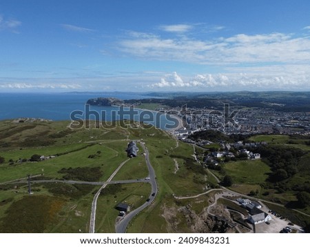 Aerial panoramic drone view over the Great Orme and towards Llandudno with the Little Orme in the background, Wales, UK