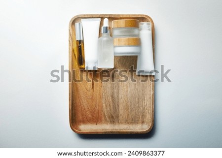 various cosmetic containers wooden tray
