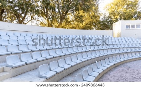 Open air public theater. Outdoor summer theater with chairs. High quality photo Royalty-Free Stock Photo #2409866443