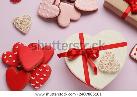 Heart shaped cookies and gift boxes on lilac background. Valentine's day celebration
