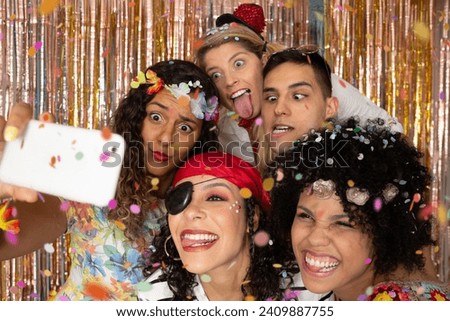 Group of costumed friends make a frowning photo at the party. Costumed Pirate and Hippie Women. enjoying Brazil Carnival Party.