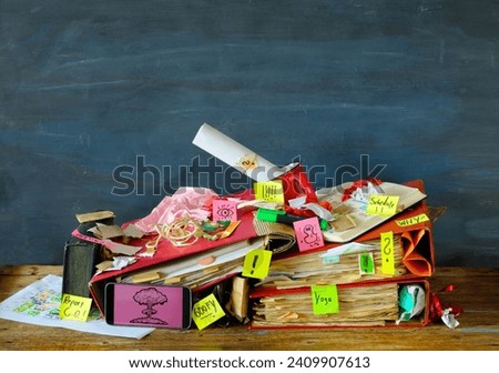 Messy workplace,chaotic office, overworked, bureaucracy,red tape concept with grungy desk,sticky notes and various office supplies, chaotic mess. Royalty-Free Stock Photo #2409907613