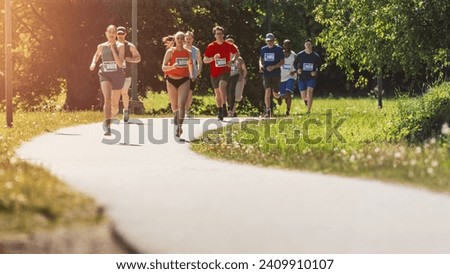 Wide Shot of Diverse Marathon Participants Competing in a Race for the Finish Line: Group of People Running Through Park Health Trail and Participating in a Marathon with Dedication Royalty-Free Stock Photo #2409910107