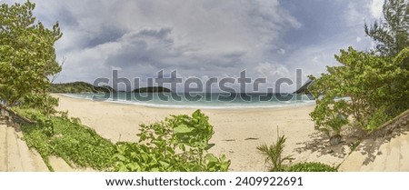 Panoramic picture of a deserted sandy beach on the Thai island of Phuket during the day