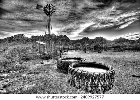 Black and White image of iconic windmill on Baylor Canyon Road east of Las Cruces, NM with the Organ Mountains in the background.
