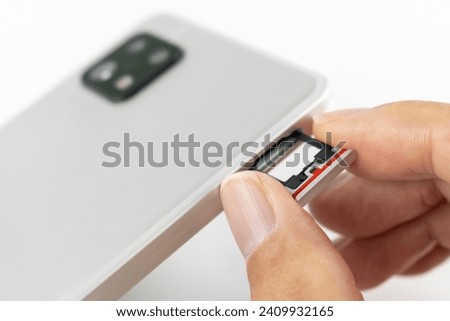 Hand of a man replacing the SIM card of a smartphone