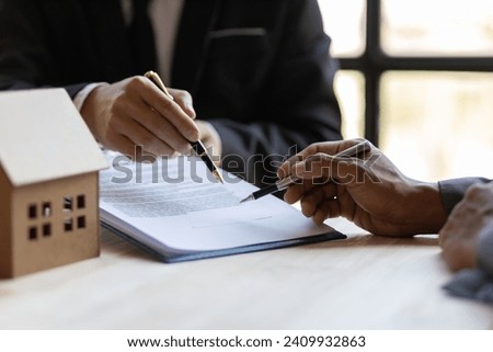 Businessmen and real estate agents discussing documents signing a legal purchase of a house.