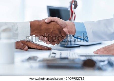 close-up handshake between two individuals, doctor and other casual shirt. doctor-patient relationship, agreement on treatment plan,  conclusion of medical consultation. Royalty-Free Stock Photo #2409952785