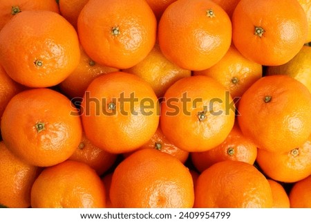 Delicious fresh tangerines as background, top view Royalty-Free Stock Photo #2409954799