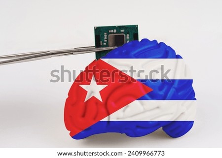 On a white background, a model of the brain with a picture of a flag - Cuba,a microcircuit, a processor, is implanted into it. Close-up
