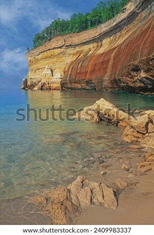 Landscape of mineral stained cliff along the eroded sandstone shoreline of Lake Superior, Pictured Rocks National Lakeshore, Michigan's Upper Peninsula, USA