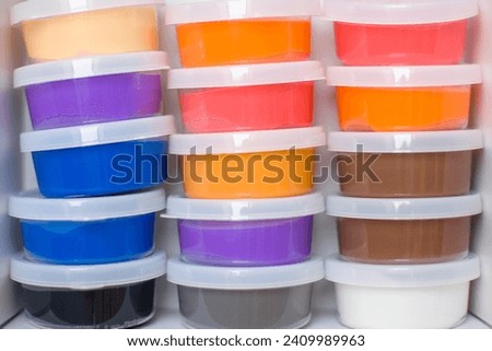 Transparent plastic containers with colorful air dry clay.