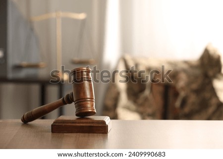 Law concept. Gavel on wooden table indoors, space for text
