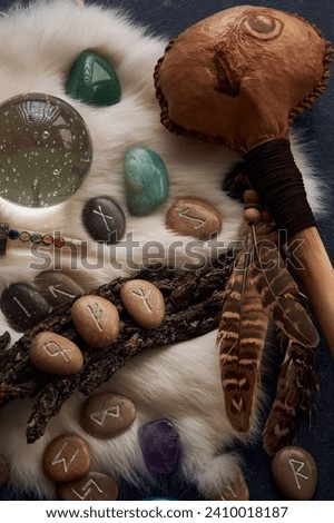 handmade stone runes on white fur Royalty-Free Stock Photo #2410018187