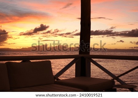 A colorful sunset seen from a beach bar.