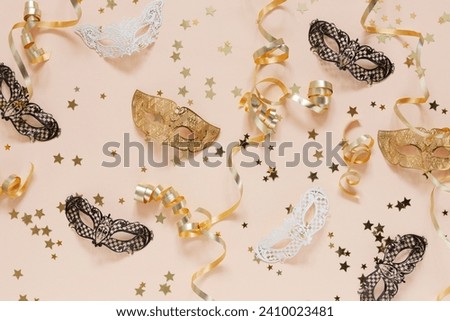 Festive background with carnival masks, streamers serpentine and golden glitter confetti in Peach Fuzz Color background of the year 2024	
