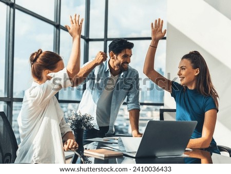 Group of happy businesspeople celebrate their successful project. Professional business team win and proud of their project at modern office. Successful teamwork, happy colleague, workplace. Tracery. Royalty-Free Stock Photo #2410036433
