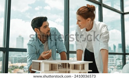 Skilled architect engineer team discussion about house model construction. Successful interior design brainstorming, sharing, talking about architectural design. Creative design. Tracery Royalty-Free Stock Photo #2410036573