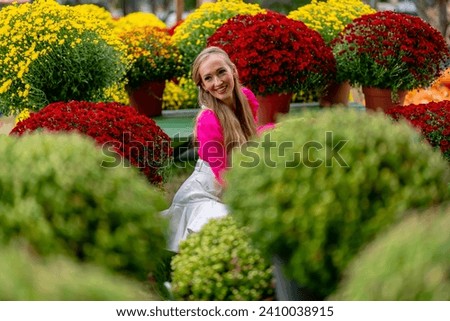 A beautiful European blonde female pics out some flowers for the upcoming fall festivals