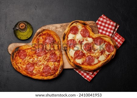 Heart-shaped pizzas: Delicious love-themed dish. Flat lay