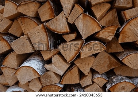 Photo of a stack of birch wood for fireplace. Background photo