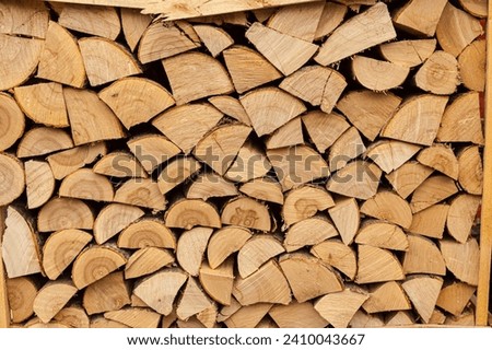 Photo of a stack of birch wood for fireplace. Background photo