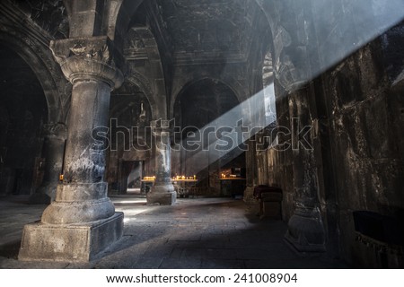 Old ancient Armenian christian church interior with amazing natural light. Geghard Monastery, 12 century Royalty-Free Stock Photo #241008904