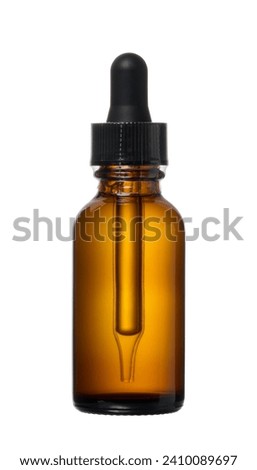 Brown glass bottle with pipette for cosmetics and oils on isolated background Royalty-Free Stock Photo #2410089697