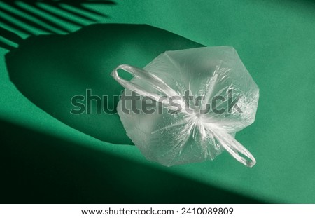 One cellophane bag on a green background.