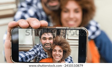 Closeup cropped image of selfie videocall vlogging blogging on cellphone with young travelers couple spouses driving van caravan home on wheels trailer together