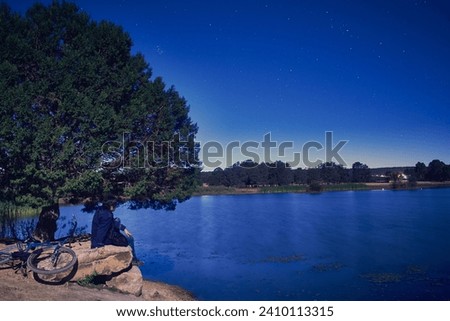 Man sitting by a lake at night in Monte Escobedo Zacatecas