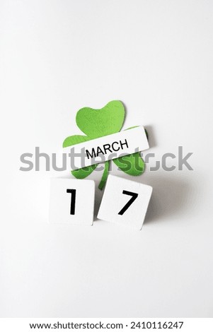 March 17 calendar and green clover leaves top view. St. Patrick's Day concept.