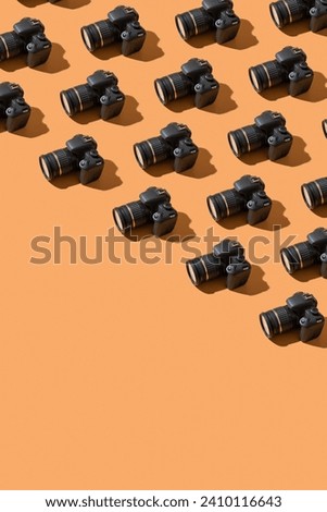 Pattern from many photo cameras on colored background. World Photography Day concept.