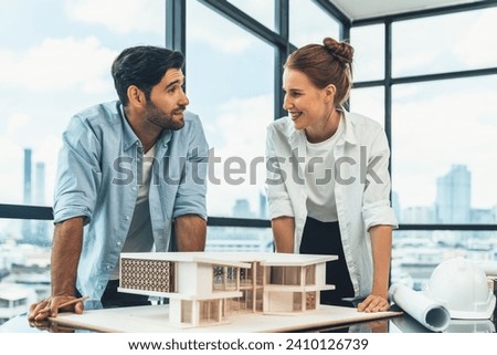 Smart caucasian architect engineer team working together to measure house model. Group of professional interior designer brainstorming and sharing ideas about design building construction. Tracery. Royalty-Free Stock Photo #2410126739