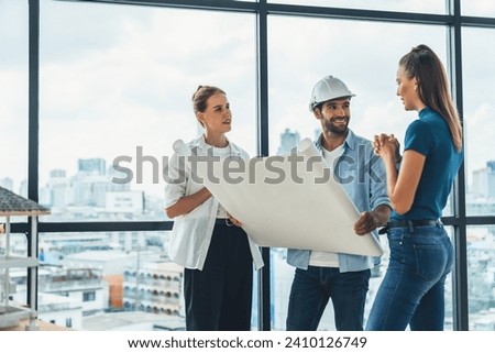 Group of architect engineer looking at project plan while brainstorming idea about building structure. Manager team discuss about building construction while standing near with city view. Tracery. Royalty-Free Stock Photo #2410126749