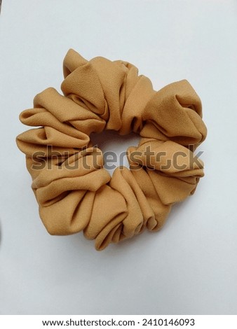 Scruncy is one item that women cannot do without. The scruncy functions as a hair tie to beautify your appearance.  Royalty-Free Stock Photo #2410146093