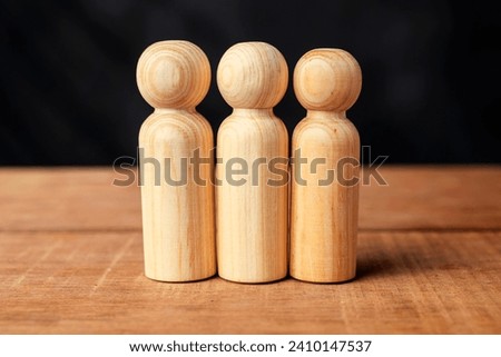 Closeup view row of a wooden figure on a wooden table