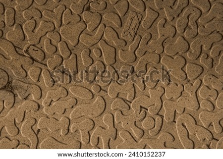 close up picture of design and curves behind a floor tile